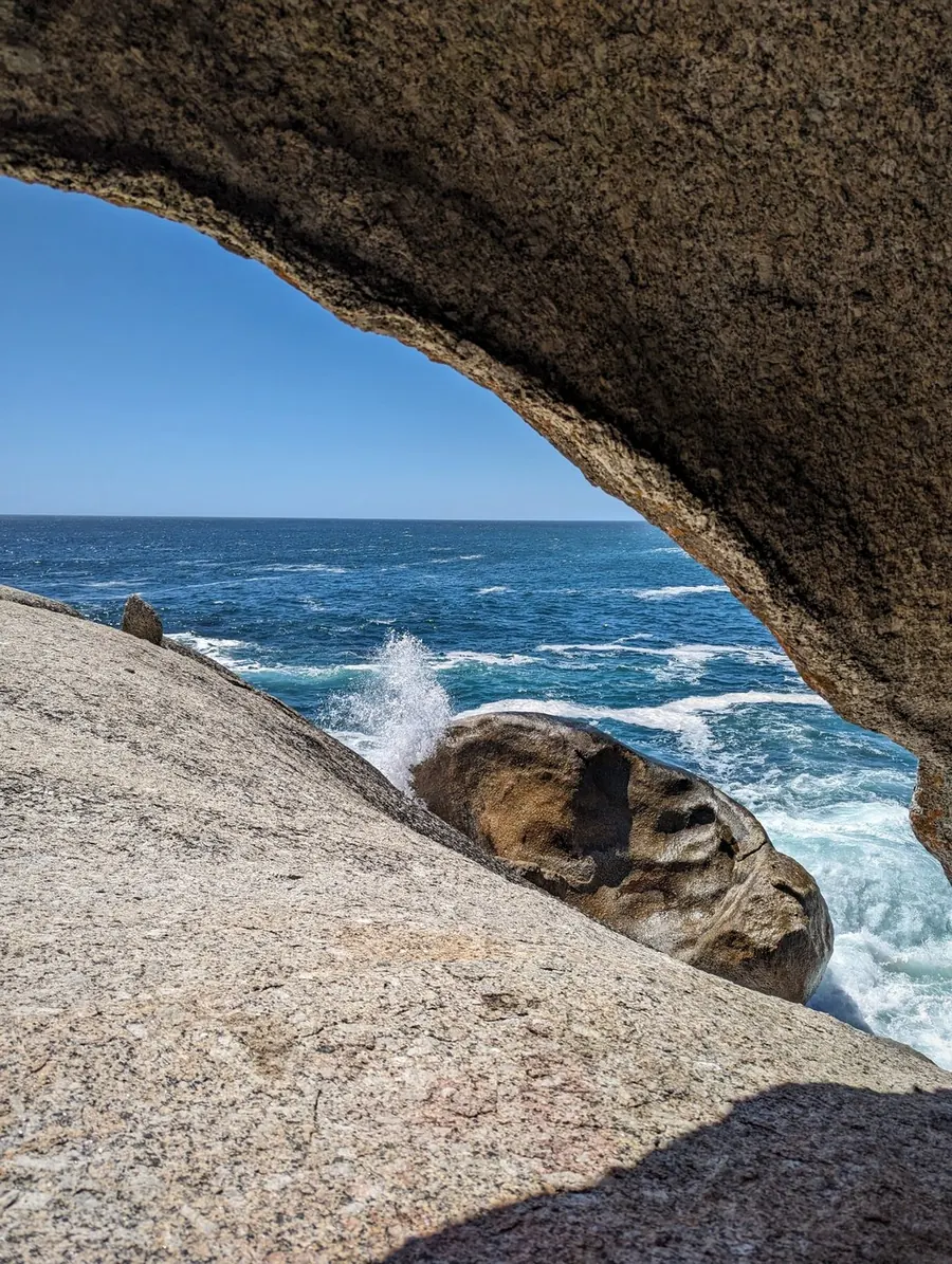 The ocean seen through a granite rock arch on the Cape Peninsula